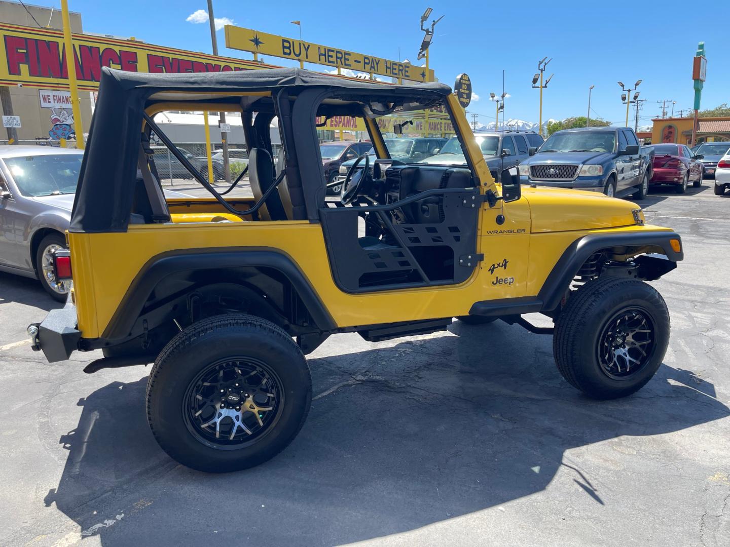 2000 Solar Yellow /Black Jeep Wrangler SE (1J4FA29P9YP) with an 2.5L 4 Cyl. engine, Manual transmission, located at 801 South State Street, Salt Lake City, UT, 84111, (801) 328-0098, 40.751953, -111.888206 - Wow extremely rare to find extra clean Jeep in immaculate condition 4x4! Low miles only 98,248 miles! Interior and exterior are both in excellent shape for the year. This is a clean title no reported accidents on the CarFax history report. It has passed emissions already and is ready to go. Featur - Photo#4